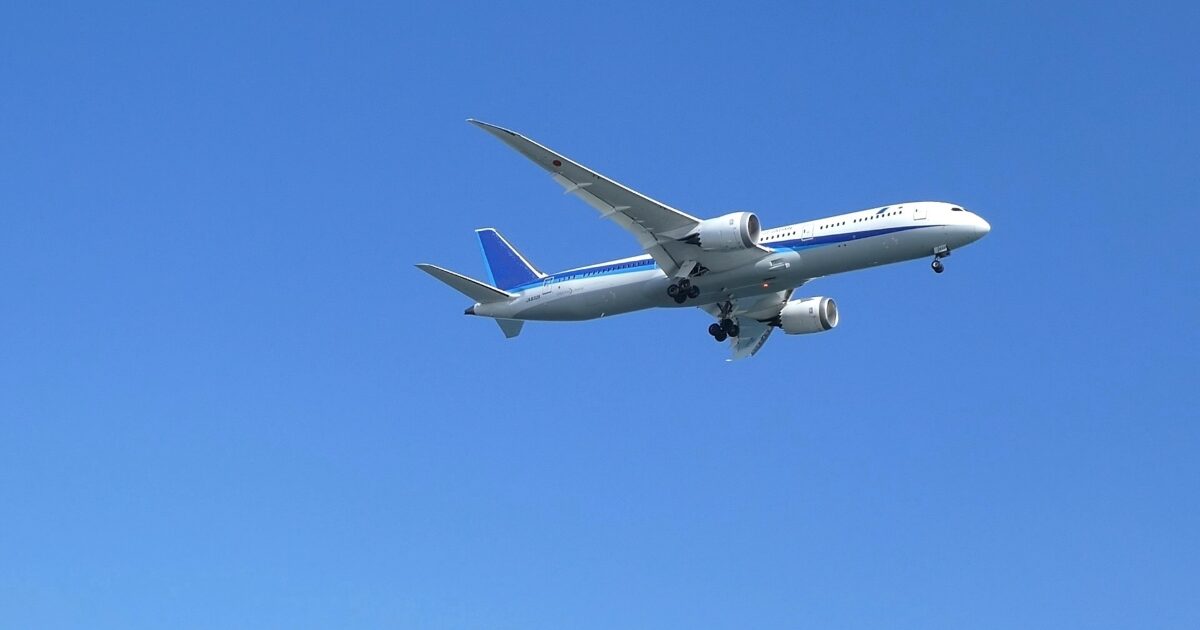 青空を飛行する着陸態勢のボーイング787旅客機